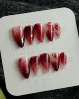 Gone with the Wind short stiletto press-on nails with marbled burgundy and gold foil accents