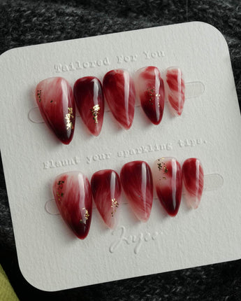 Gone with the Wind short stiletto press-on nails with marbled burgundy and gold foil accents