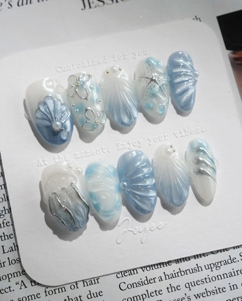 Great Barrier Blue handmade press-ons with pearly shell texture and starry sea mood