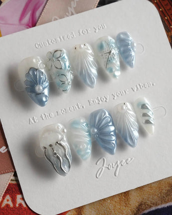 Great Barrier Blue modern ocean nails with shell-carved texture and shimmering blue polish