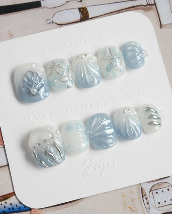 Great Barrier Blue extra short squoval nails with pearly shells and silver-blue shine