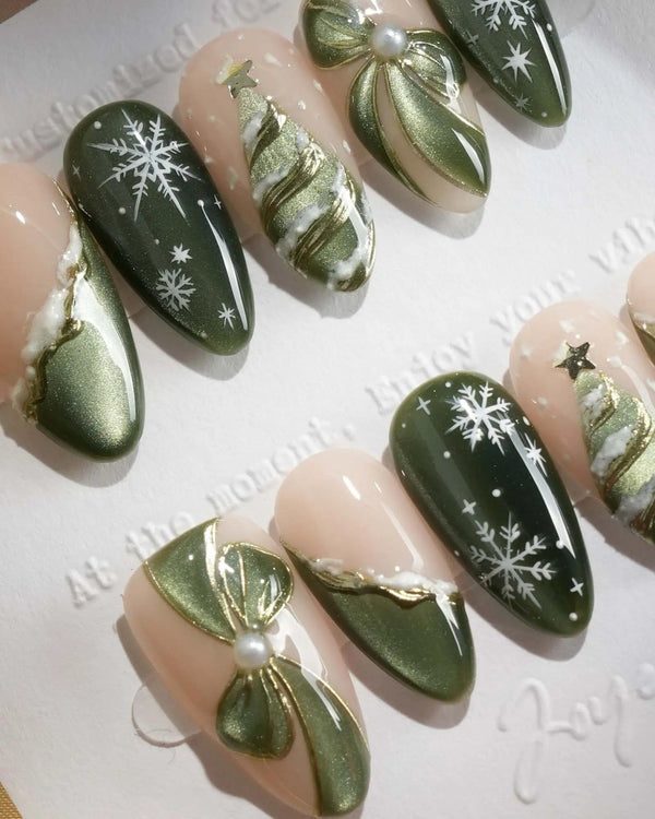 Green Christmas press-on nails with bow and snowflake details