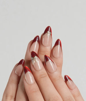 Bow French press-on nails with red chrome French tips, gold outline details and bow nail art