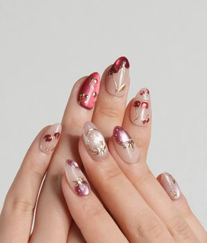 Crystal Berry press-on nails with red cat-eye cherry details and gold outline accents on nude base