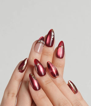 Molten Rouge press-on nails with deep red cat-eye shimmer and gold outline details