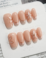 Haze Bloom press-on nails — Elegant Nude Pink, Embossed Florals & French Gold Edging. handmade nail art by Joyee Nails