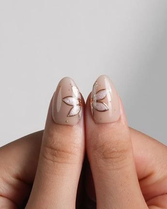 Haze Bloom nail art close-up showing Elegant Nude Pink, Embossed Florals & French Gold Edging. details