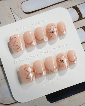 Haze Bloom press-on nails in extra short coffin shape — Elegant Nude Pink, Embossed Florals & French Gold Edging.