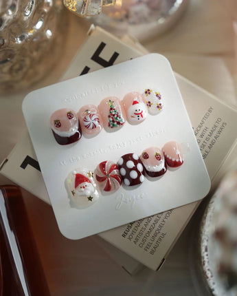Holiday Party press-on nails in extra short squoval shape — pearl nude cat eye snowflake bow silver glitter soft sheen