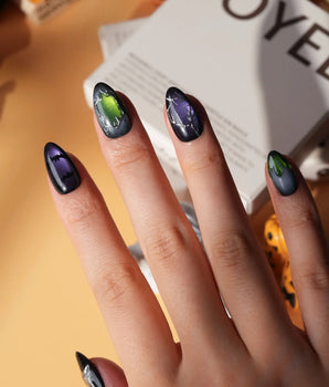 Poison Apple press on nails with a green skull poison apple, fanged grin, bat and 3D silver crown on green and purple cat eye - image 2
