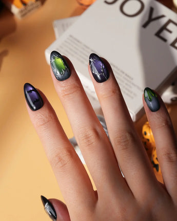 Poison Apple press on nails with a green skull poison apple, fanged grin, bat and 3D silver crown on green and purple cat eye - image 2