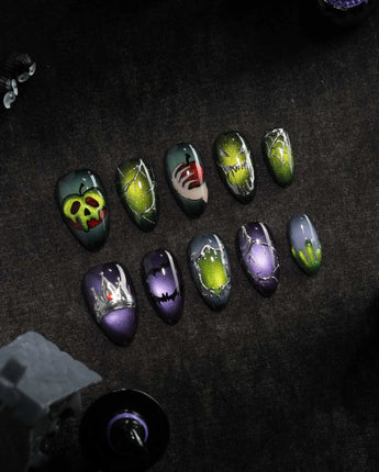Poison Apple press on nails with a green skull poison apple, fanged grin, bat and 3D silver crown on green and purple cat eye - image 3