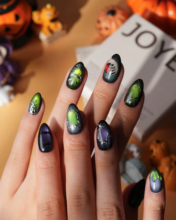Poison Apple press on nails with a green skull poison apple, fanged grin, bat and 3D silver crown on green and purple cat eye - image 4