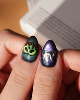 Poison Apple press on nails with a green skull poison apple, fanged grin, bat and 3D silver crown on green and purple cat eye - image 5