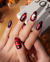 Blood Moon press on nails with black bats, bare trees, a ghost holding a pumpkin and a silver glitter spider on deep red cat eye - image 2