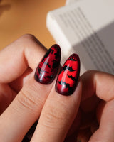 Blood Moon press on nails with black bats, bare trees, a ghost holding a pumpkin and a silver glitter spider on deep red cat eye - image 4