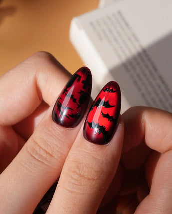 Blood Moon press on nails with black bats, bare trees, a ghost holding a pumpkin and a silver glitter spider on deep red cat eye - image 4