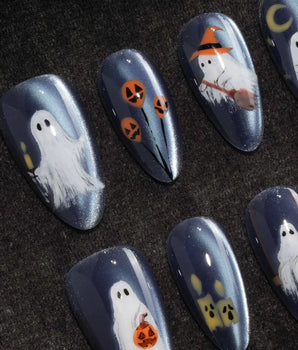 Ghost Errands press on nails with little white ghosts holding a pumpkin, a broom and an umbrella on slate blue cat eye - image 1