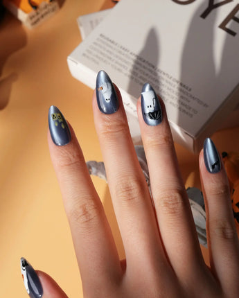 Ghost Errands press on nails with little white ghosts holding a pumpkin, a broom and an umbrella on slate blue cat eye - image 2