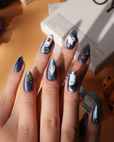 Ghost Errands press on nails with little white ghosts holding a pumpkin, a broom and an umbrella on slate blue cat eye - image 6