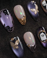 Black Rose Ball press on nails with black roses, a gold butterfly, pearls and a ghost in a gold frame on lilac violet pearl cat eye - image 1