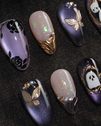 Black Rose Ball press on nails with black roses, a gold butterfly, pearls and a ghost in a gold frame on lilac violet pearl cat eye - image 1