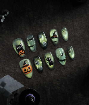 Witch's Cat press on nails with a black cat on a jack-o-lantern, witch hat, skulls, bats and a spider web on green shimmer cat eye - image 1