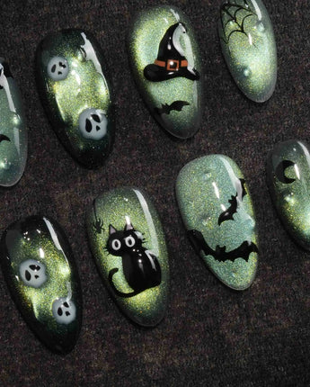 Witch's Cat press on nails with a black cat on a jack-o-lantern, witch hat, skulls, bats and a spider web on green shimmer cat eye - image 3