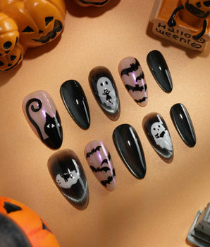 Cat Sitter press on nails with a long-tailed black cat, a row of bats and a white ghost holding a kitten on black and nude with pink shimmer - image 2