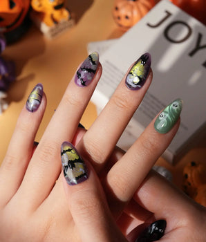 Fright Night press on nails with a fanged black cat, bats, white skulls and spider webs on purple gold and green cat eye - image 2
