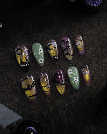 Fright Night press on nails with a fanged black cat, bats, white skulls and spider webs on purple gold and green cat eye - image 3