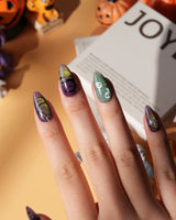 Fright Night press on nails with a fanged black cat, bats, white skulls and spider webs on purple gold and green cat eye - image 4