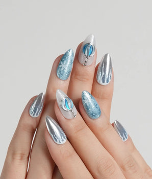 Frozen Dream handmade press-on nails featuring ice blue ombre silver chrome snowflake charm