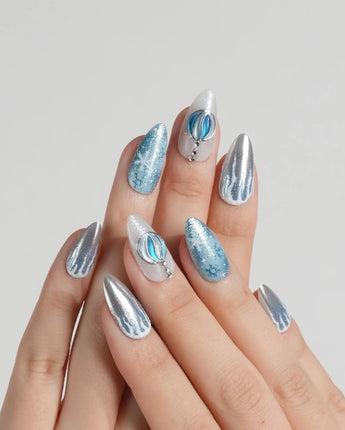 Frozen Dream handmade press-on nails featuring ice blue ombre silver chrome snowflake charm