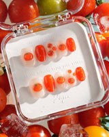 Icy Tomato extra short oval nails with clear jelly shine, orange-red tomatoes, and dewdrops