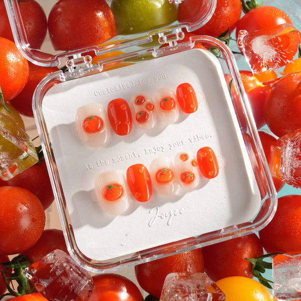 Icy Tomato extra short oval nails with clear jelly shine, orange-red tomatoes, and dewdrops