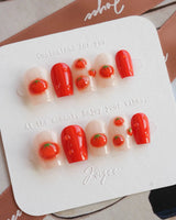 Icy Tomato glossy summer press-on nails with clear base and raised tomato details