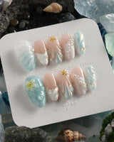 Yasawa Blue island nails with translucent blue swirls, pearl strings, and shell-like texture