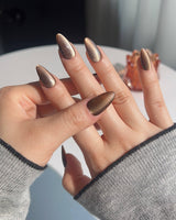 Close-up of Arabica Cat-eye nails with coffee brown shimmer and magnetic cat-eye effect