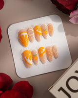 Juicy Juicy orange and white press-on nails with sculpted fruit pulp accents
