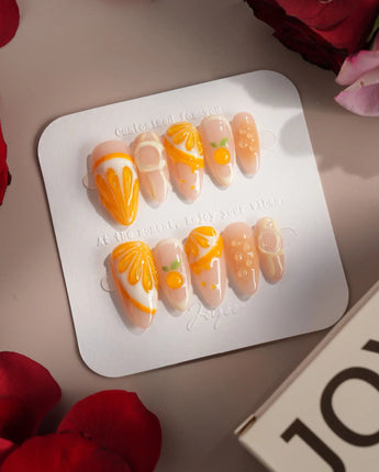 Juicy Juicy orange and white press-on nails with sculpted fruit pulp accents
