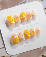 Juicy Juicy tropical citrus press-on nails with orange slice nail art