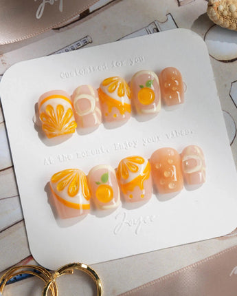 Juicy Juicy summer press-on nails with orange slices and glossy peel texture