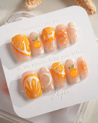 Juicy Juicy glossy citrus press-on nail set in orange and white tones