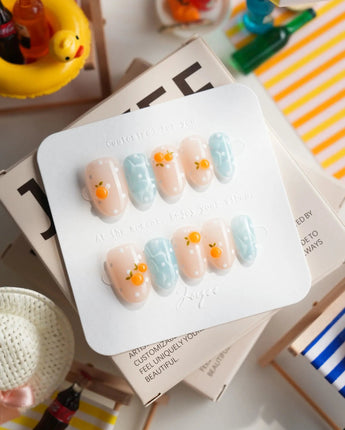 Juicy Summer citrus press-on nails with orange fruit charms and fizzy polka dots