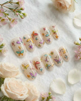 Kiln Spring press-on nails in short oval shape — Colorful Butterflies, Hand-painted Golden Outlines & Glitter Petals.
