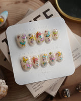 Kiln Spring press-on nails in extra short oval shape — Colorful Butterflies, Hand-painted Golden Outlines & Glitter Petals.