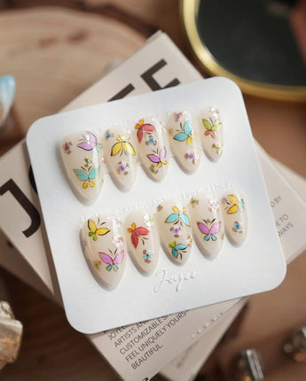 Kiln Spring press-on nails in short almond shape — Colorful Butterflies, Hand-painted Golden Outlines & Glitter Petals.
