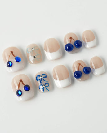 Klein Blue Cherry extra short squoval nails with blue cherry French tip design