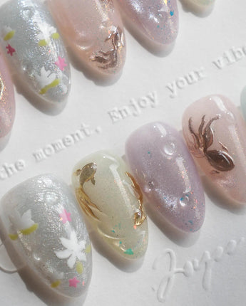Koi Dream press-on nails in extra short almond shape — Shimmering Mermaid Pearl, Metallic Relief Goldfish & cat eye effict.